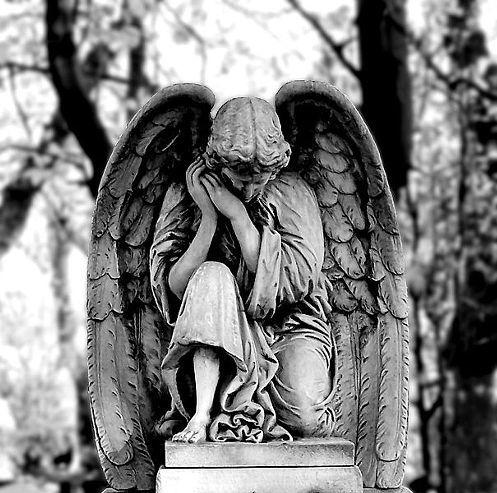 Statua di un angelo in lutto, in bianco e nero